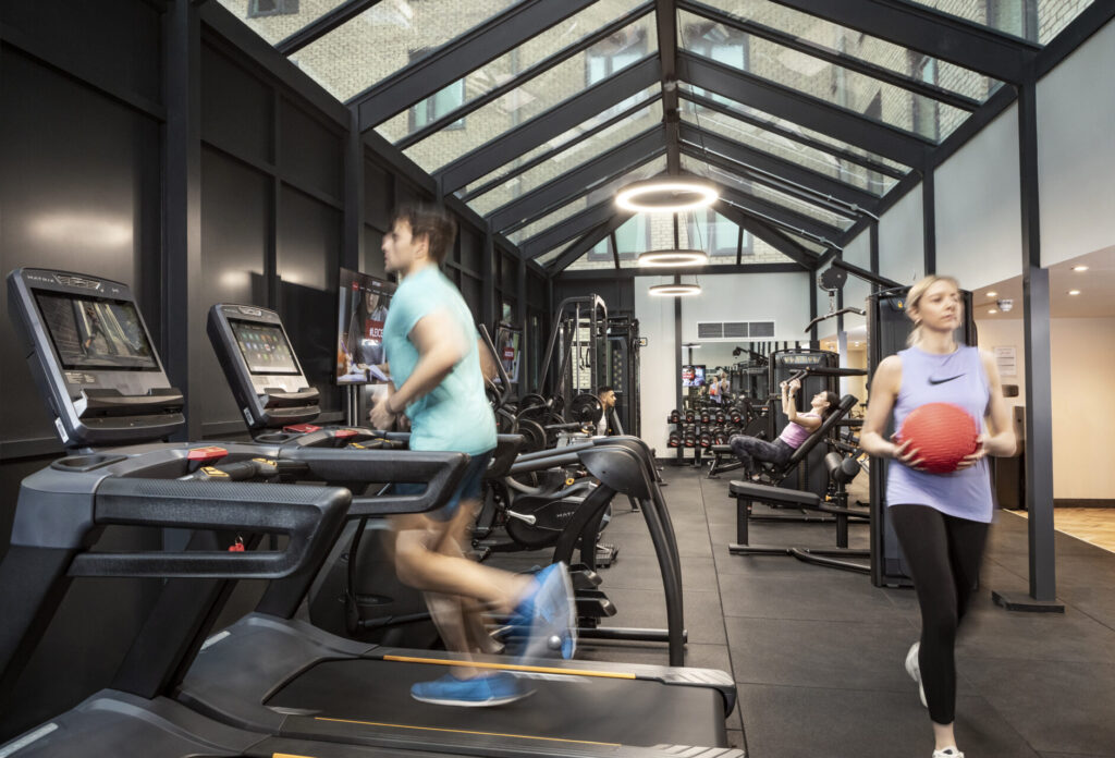 Fully-equipped gym at Study In Leicester with students exercising