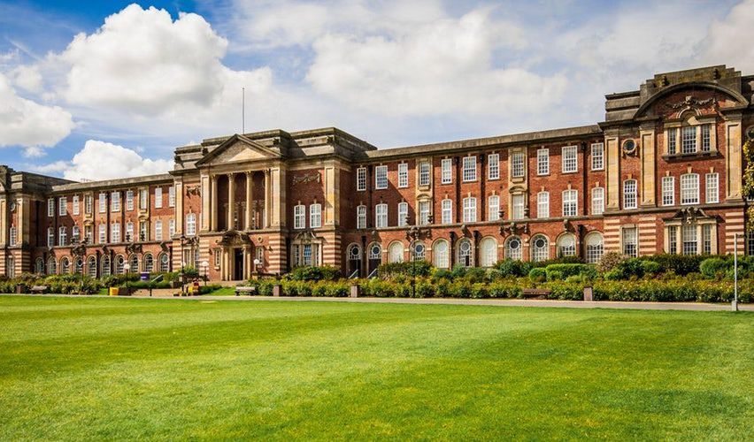 Leeds Beckett University exterior shot, showing its lawn and building on a cloudy day