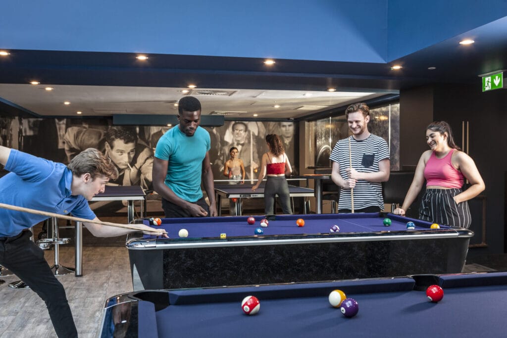 Students having fun playing pool at Study Inn student accommodation