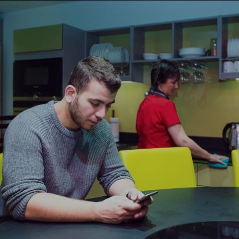 University students checking his phone at university