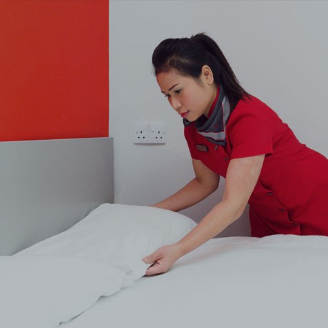 Study Inn housekeeping services team member changing the bedsheets