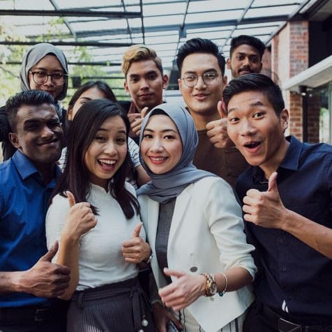 A group of university students posing for a group photo at uni
