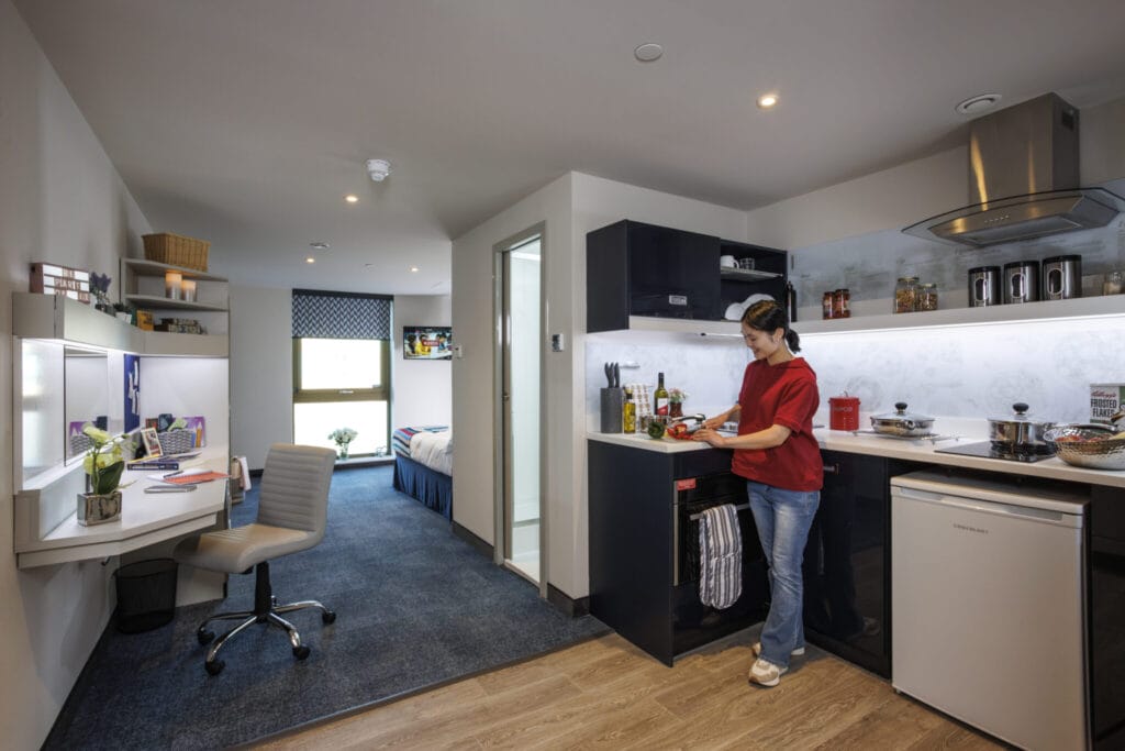 Study Inn Leeds, student accommodation in Leeds. Sapphire Plus studio with student cooking in the kitchenette.