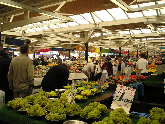 Shoppers looking at produce at Leicester market
