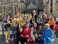 Runners pose for a photo during the Otley Run in Leeds.