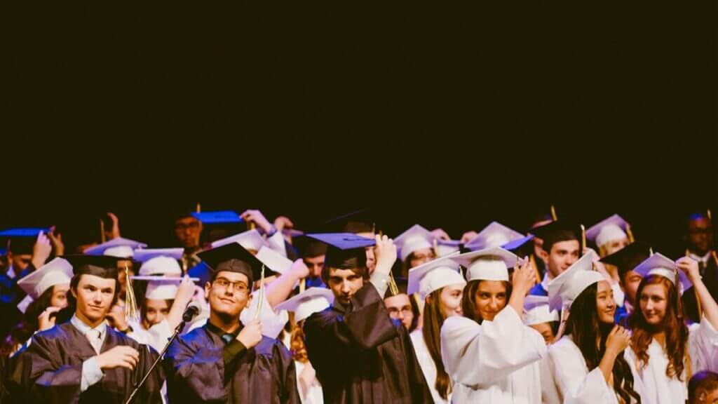 University students at their graduation wearing graduation gowns and hats.