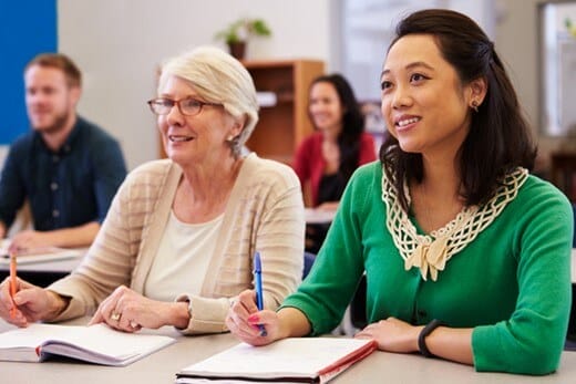 Mixture of older and younger university students in a classroom.
