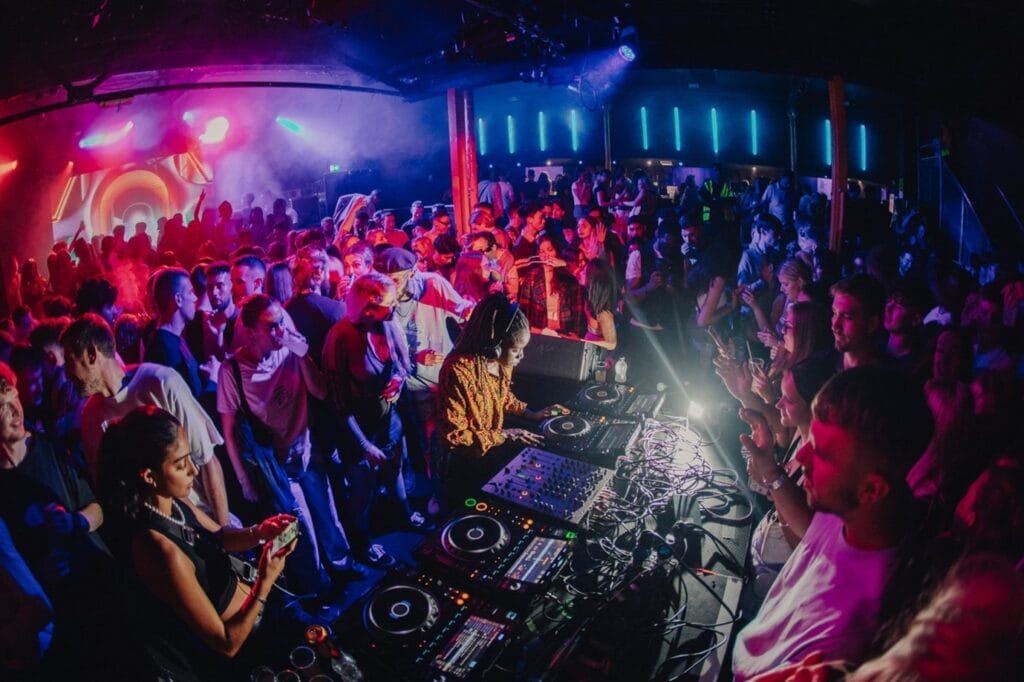 The Warehouse night club in Leeds packed with students dancing the night away to the DJ and its DJ equipment.