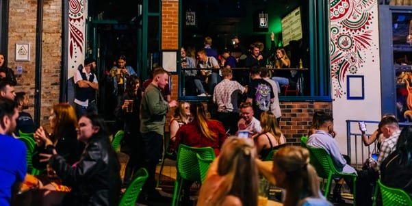 Verve shot from the outside on a summers night. Students sat outside in many tables, chatting and drinking.
