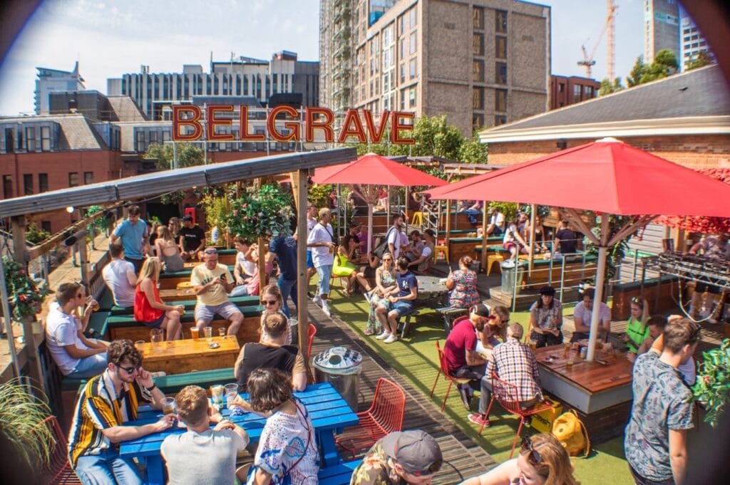 Belgrave Music Hall & Canteen in Leeds, on a sunny day, full of customers chatting, having drinks.