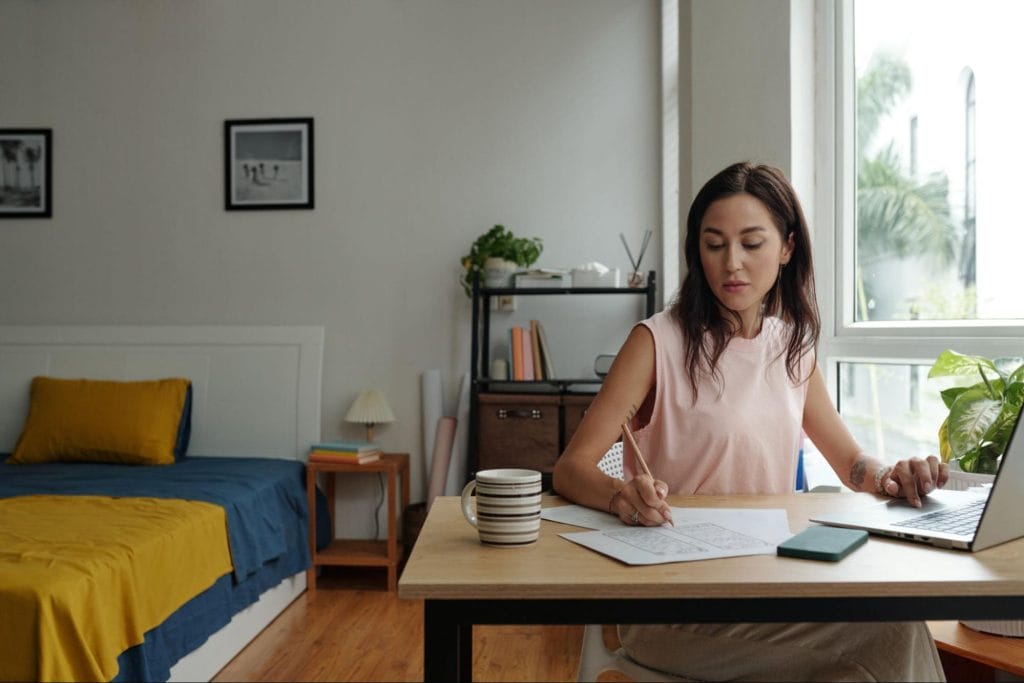 Student studying in a bright, modern bedroom workspace, ideal for focused learning and comfortable living in student accommodation, Exeter
