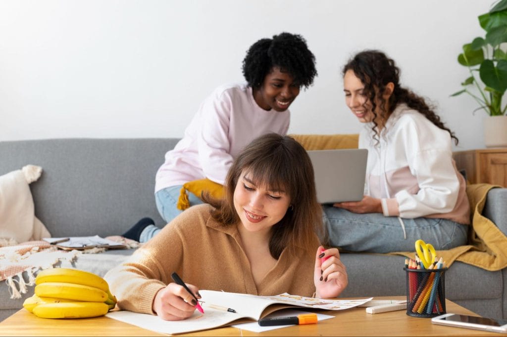 Group of students collaborating and studying together in a living space at Exeter student accommodation