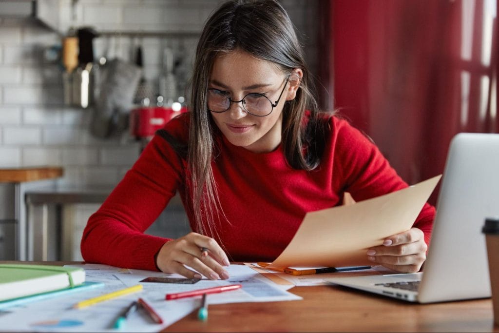 Female student studying with documents in modern Leicester student accommodation