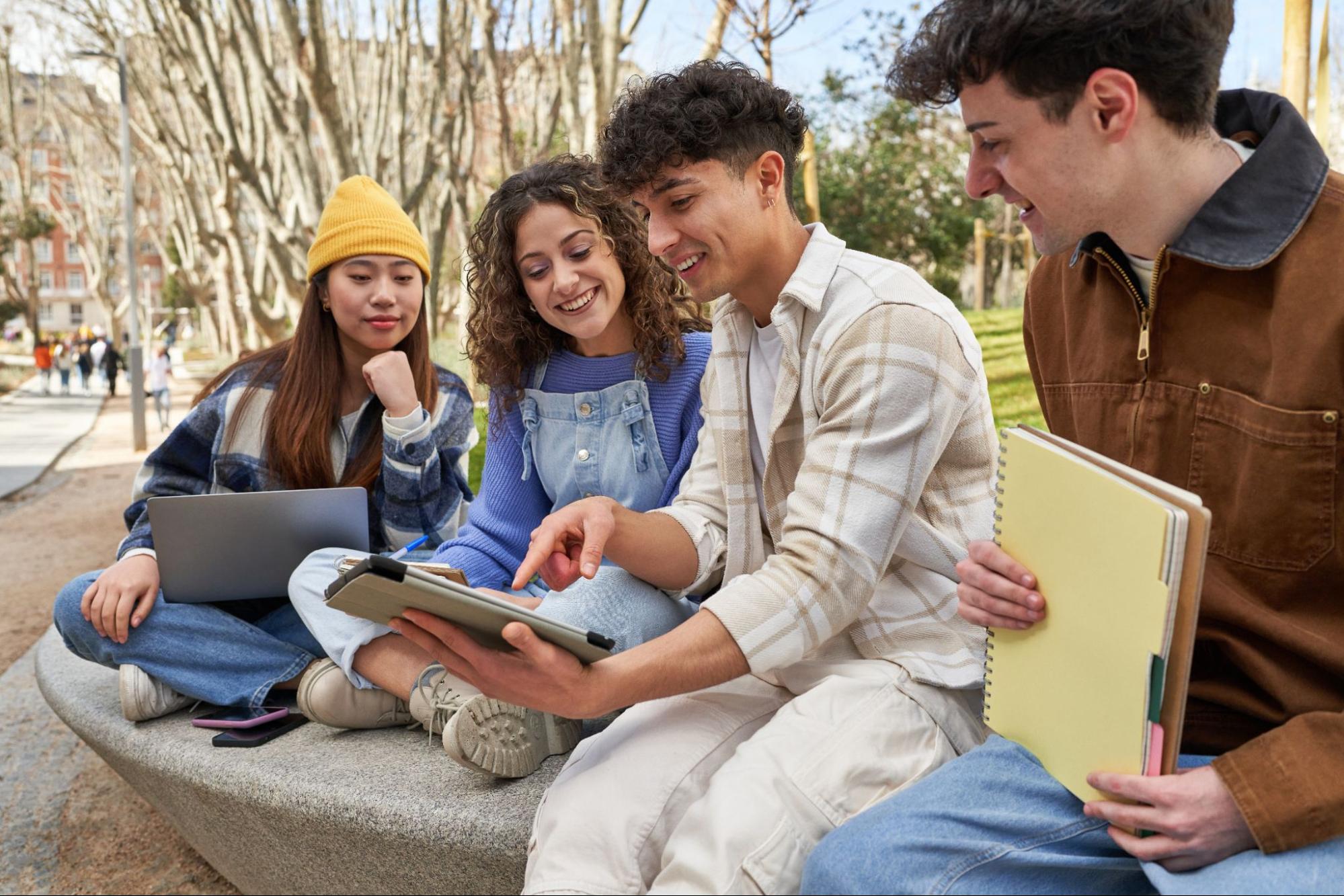 Group of university students studying together outdoors near luxury student housing in Nottingham