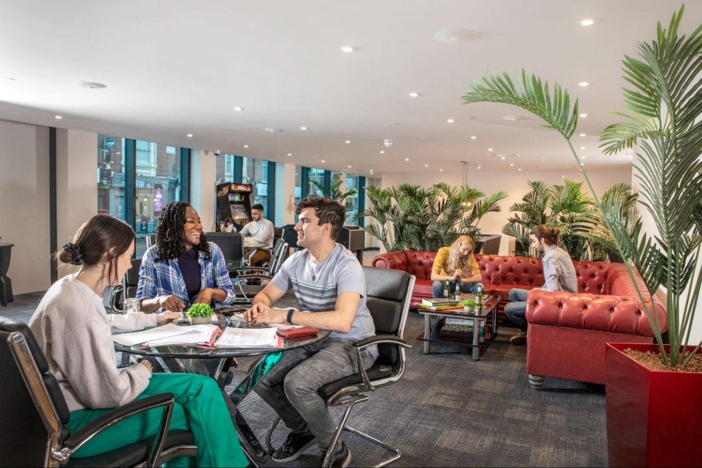 Group of students socialising in the seating area at Study Inn Leicester student accommodation, Reynard House