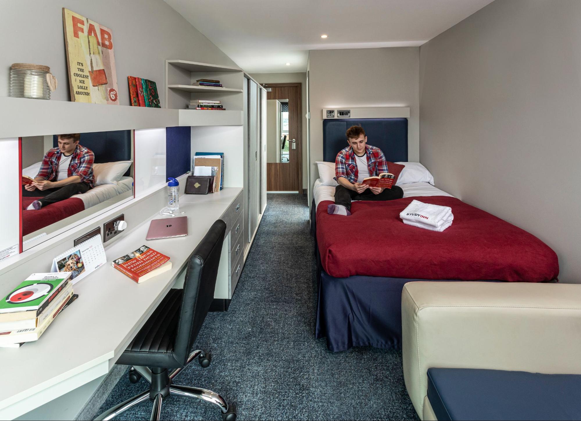 student reading a book at the Study Inn accommodation in Exeter.